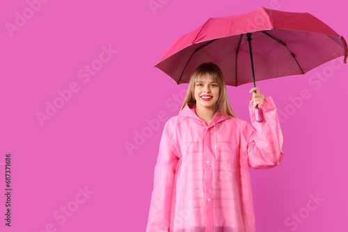 Young woman in pink raincoa...