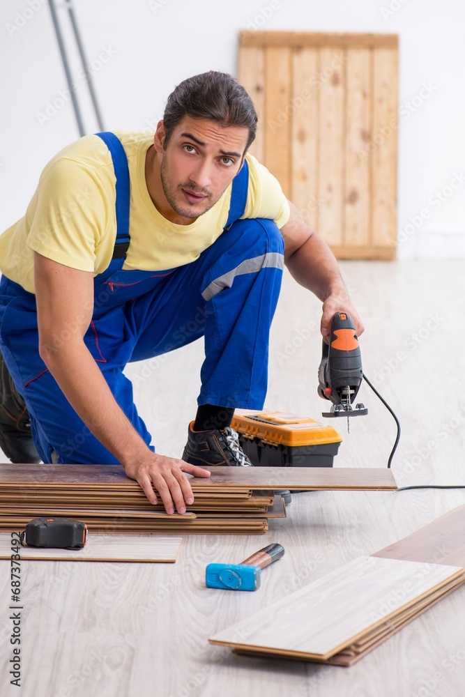 Young male contractor working indoors Young male contractor working indoors