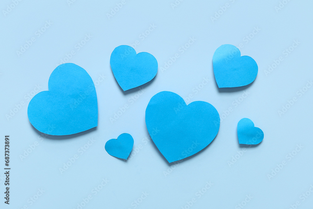 Composition with blue paper hearts on color background. Valentines Day celebration