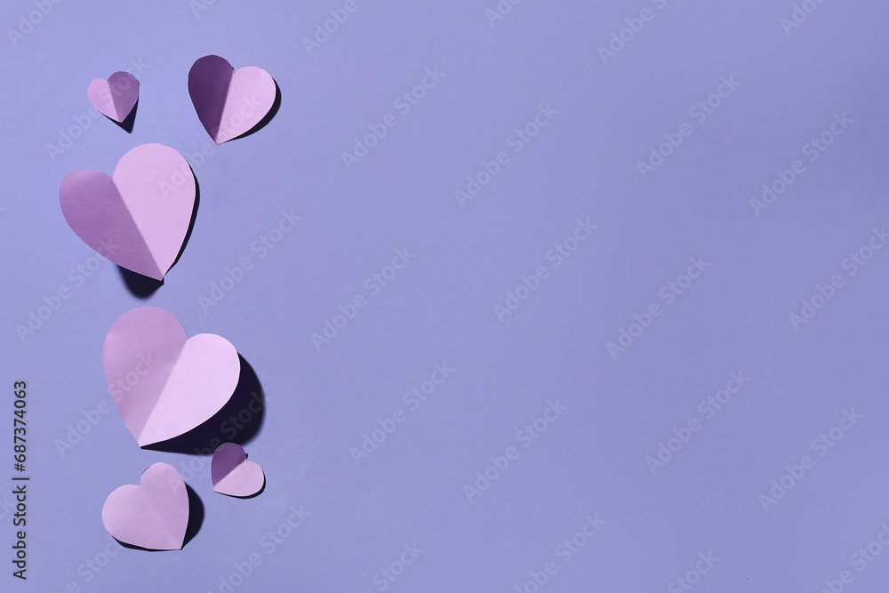 Composition with paper hearts on lilac background. Valentines Day celebration