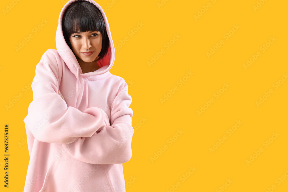 Beautiful young stylish woman on yellow background Beautiful young stylish woman on yellow background