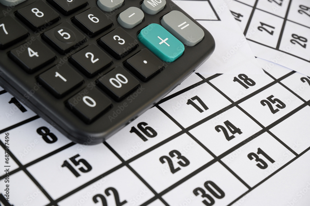 Calculator on calendar pages close up. Accountancy and planning payments concept. Calculator on calendar pages close up. Accountancy and planning payments concept.