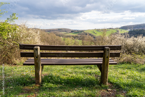 Bench on the hill with a view of the landscape in spring