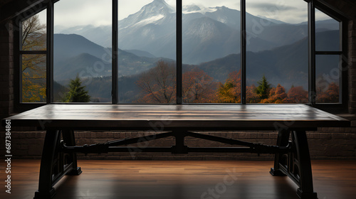 Table in empty room with large windows - snow on mountains in background - rustic - country - vacation - getaway - travel 