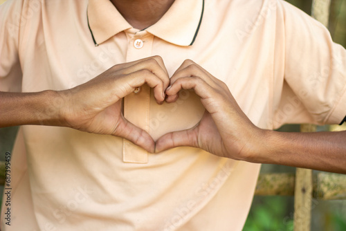 A man made love with hands and blurred background