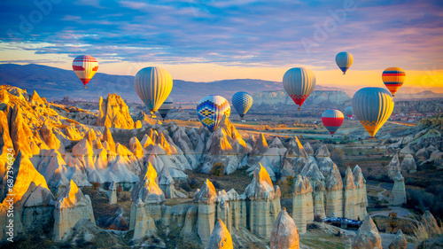 Amazing panoramic view of sunrise Cappadocia landscape with colorful hot air balloons in the love valley- Travel destination concept Turkey #687396424