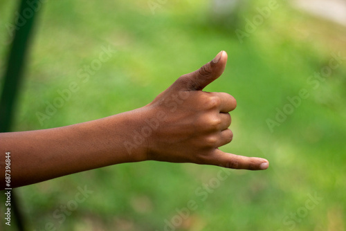 A man pointing two fingers of his hand forward and blur background © Rokonuzzamnan