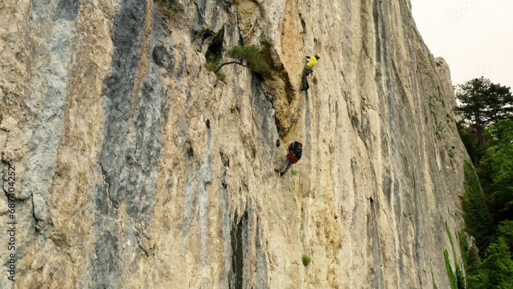 The Thrilling Ascent: A Man Conquering the Vertical Challenge with Courage and Determination The Thrilling Ascent: A Man Conquering the Vertical Challenge with Courage and Determination