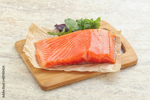 Raw salmon fillet over board