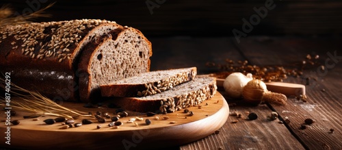 Sliced rye bread with seeds on wooden board.