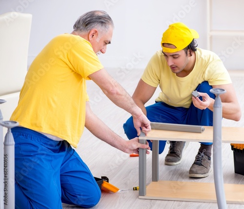 Two contractors carpenters working indoors