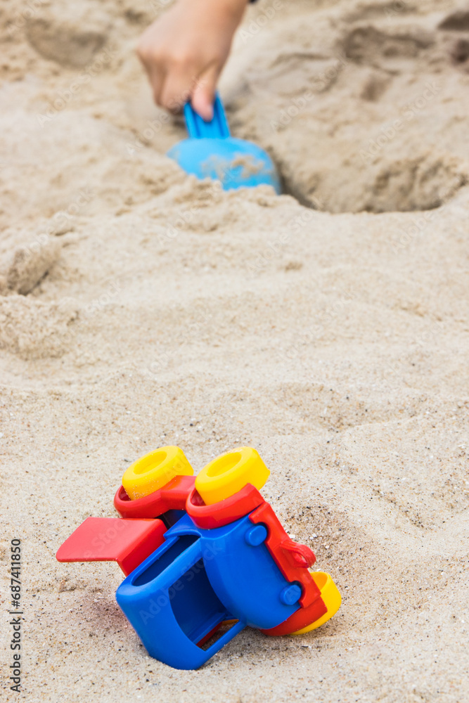 Little boy with children toys on sand at beach. Relax or playing in summer. Vacation time Little boy with children toys on sand at beach. Relax or playing in summer. Vacation time