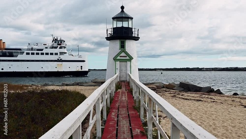 Steam Boat Ferry passing at Sunrise at Brant Point Lighthouse, Nantucket Island, Massachusetts, USA