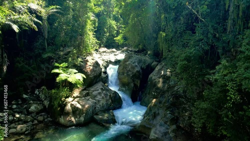 Establish Aerial view Lubuak Ngalauan Waterfall or known as Sarasah Lubuak Rantiang is located in the Bangek River area, Balai Gadang Village, Koto Tangah District, Padang City. photo