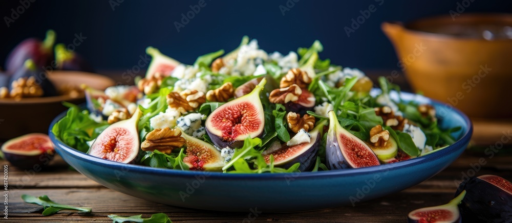 Fig salad on blue wooden table with cheese and walnuts. Fig salad on blue wooden table with cheese and walnuts.