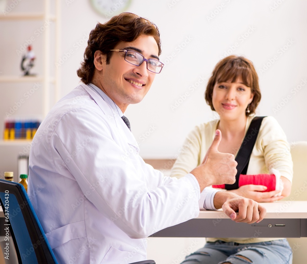 Young woman visiting doctor traumatologist Young woman visiting doctor traumatologist