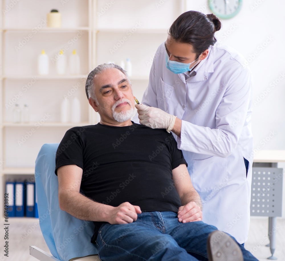 Old man visiting young doctor for plastic surgery Old man visiting young doctor for plastic surgery
