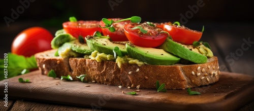 Closeup of a delicious sandwich with avocado and tomatoes on wholegrain bread.