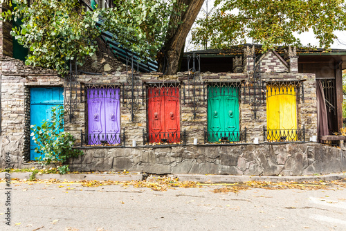 multicolored shutters and the door of a one-story house