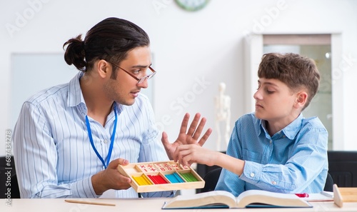 Young father helping his son to prepare for exam photo