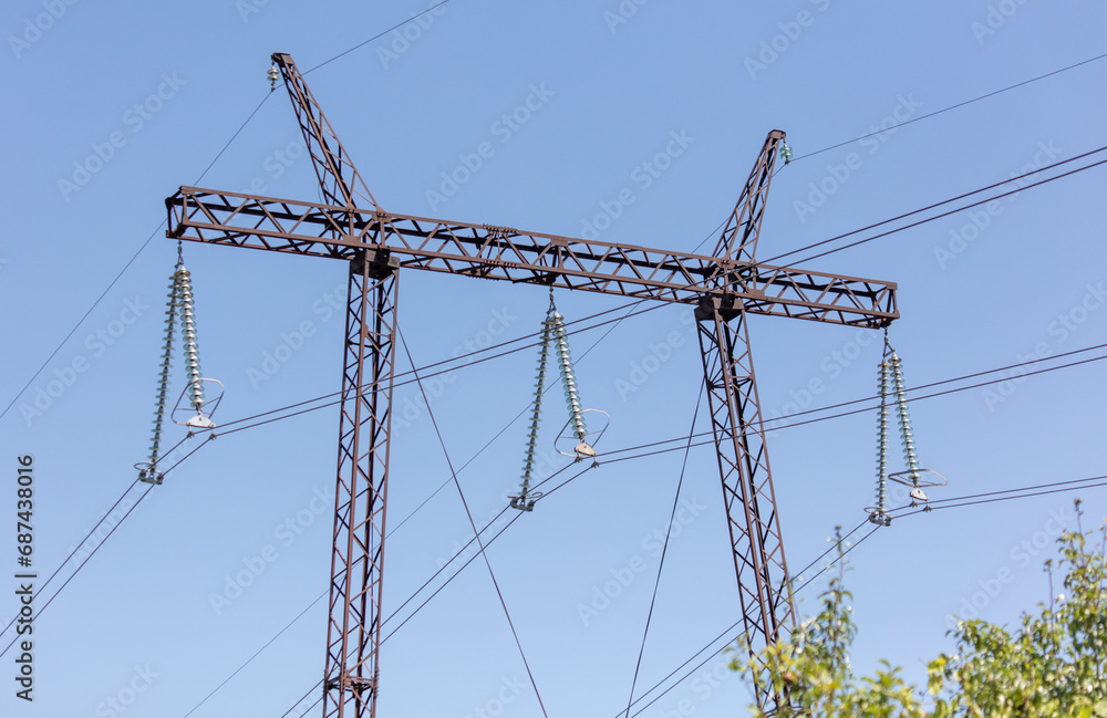 Metal electric pole against the blue sky