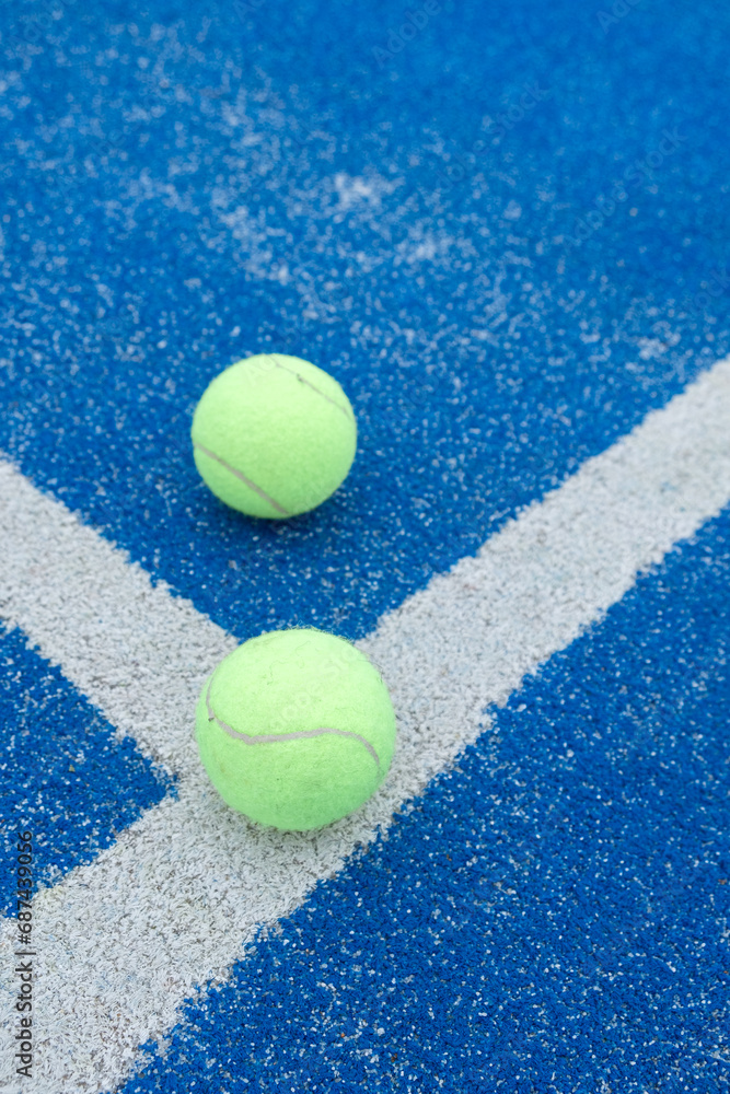 blue paddle tennis court and balls, racket sports courts concept