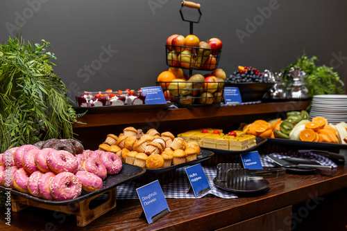 Buffet Table with Fresh Fruits, Pastries, and Desserts in a Stylish Presentation in hotel