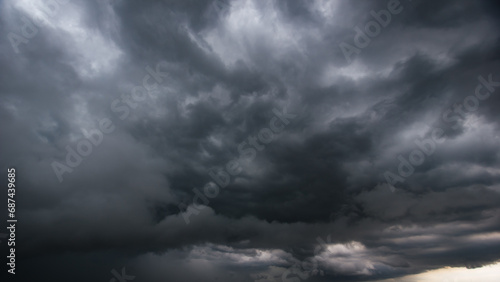 The dark sky with heavy clouds converging and a violent storm before the rain.Bad or moody weather sky and environment. carbon dioxide emissions, greenhouse effect, global warming, climate change.