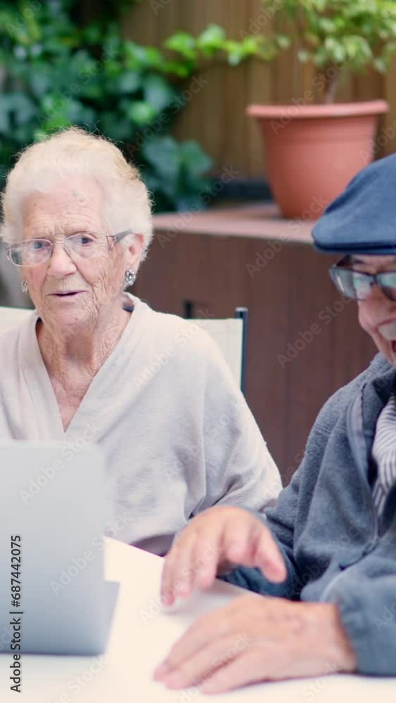 Grandparents waving during a video call with laptop Grandparents waving during a video call with laptop