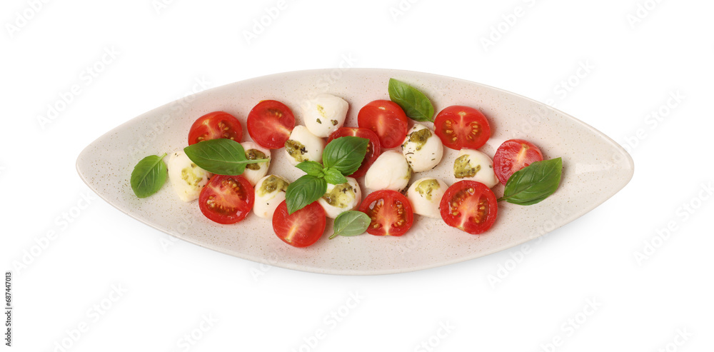 Plate of tasty Caprese salad with mozzarella, tomatoes, basil and pesto sauce isolated on white, top view Plate of tasty Caprese salad with mozzarella, tomatoes, basil and pesto sauce isolated on white, top view