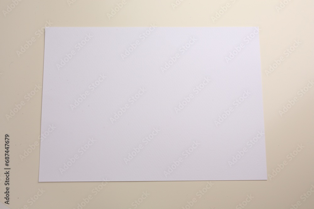 Sheet of parchment paper on beige background, top view Sheet of parchment paper on beige background, top view