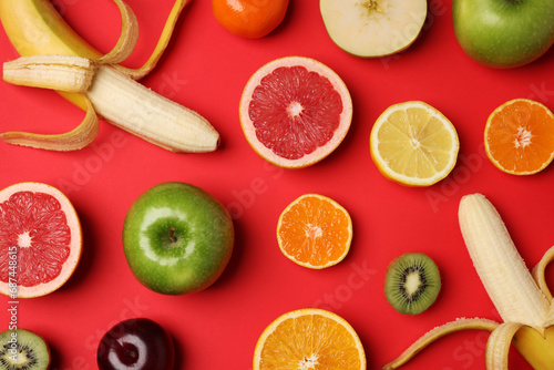 Different ripe fruits on red background  flat lay