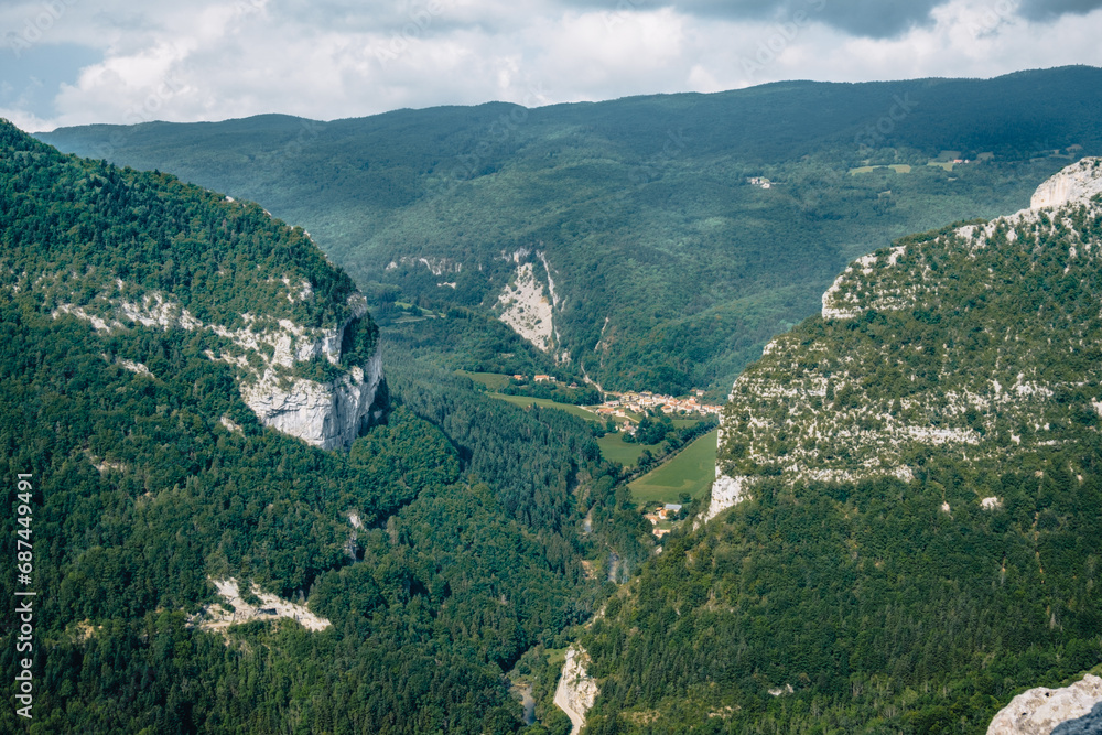 View on the Alps and the mountains of Vercors mountain range from the hiking trail of the Bourne river canyon in the French Alps (Isere)
