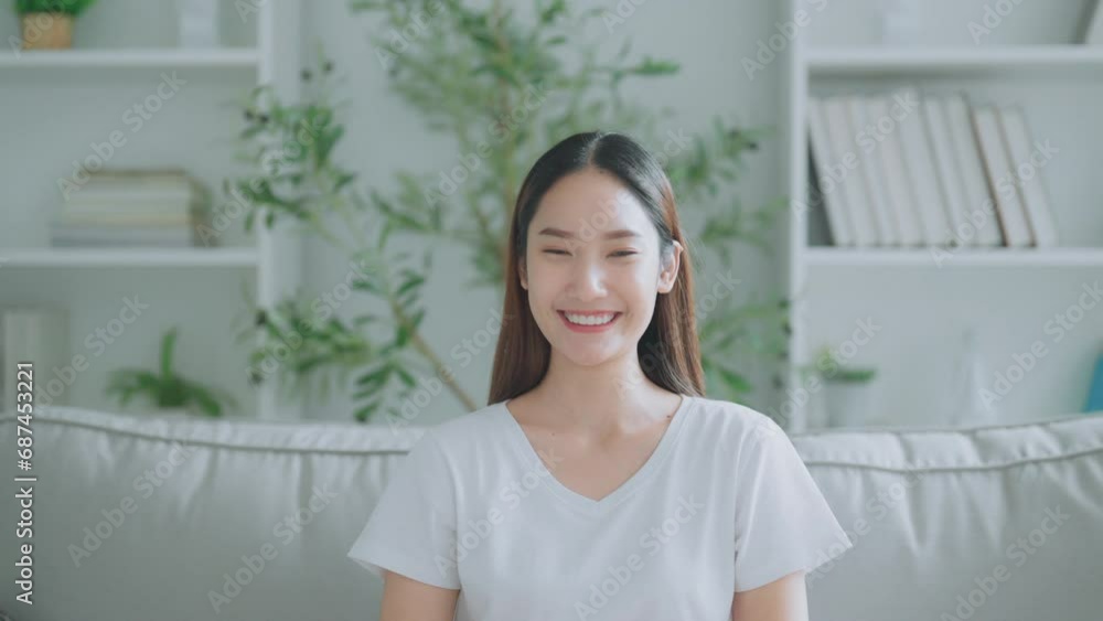 Front view of a cute young Asian woman smiling and looking at the camera. Happy facial expressions and positive emotions Front view of a cute young Asian woman smiling and looking at the camera. Happy facial expressions and positive emotions