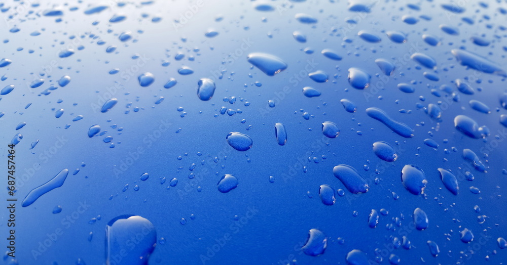 Drops of rainwater on blue metal background after nanoceramics polishing technology closeup Drops of rainwater on blue metal background after nanoceramics polishing technology closeup
