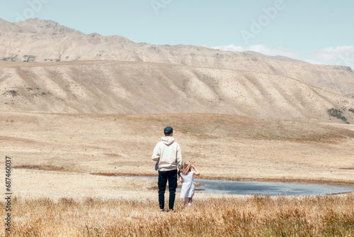 Dad and little daughter are walking in nature in New Zealand. Family and childhood