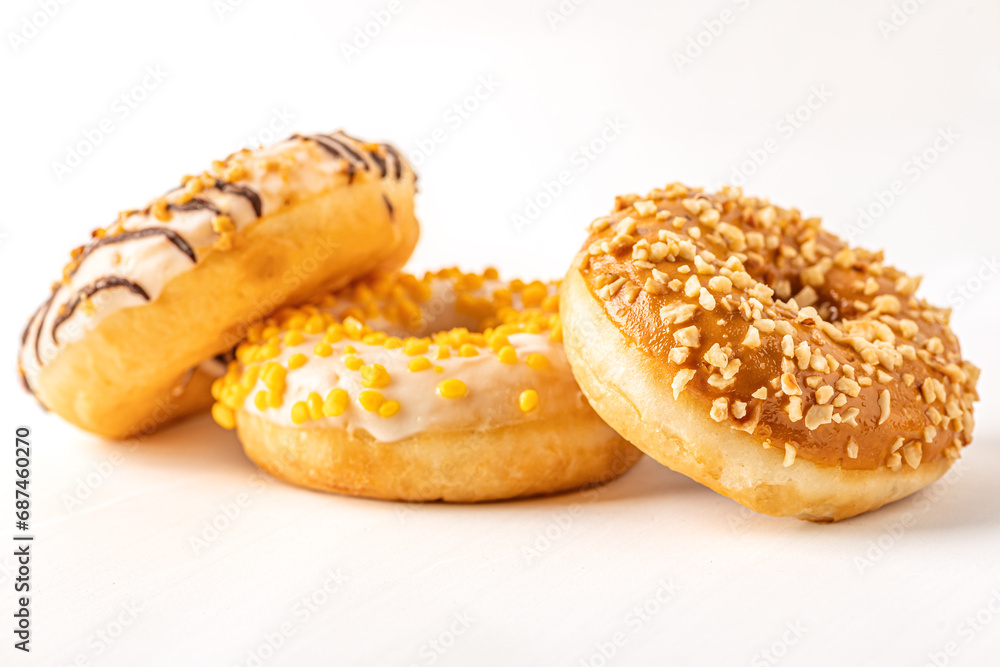 assorted glazed donuts on white surface assorted glazed donuts on white surface