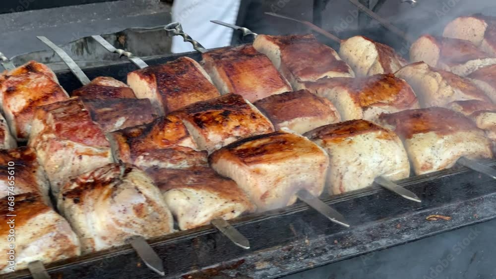 Fresh meat is grilled outdoors. Shish kebab is grilled in a cafe. Fresh meat is grilled outdoors. Shish kebab is grilled in a cafe.