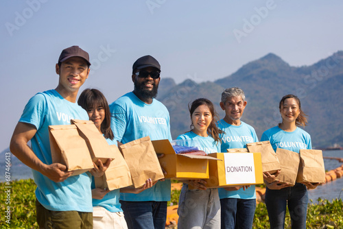 фотографія Diversity group of volunteer people joining together in money raising event for