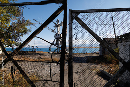 old abandoned gate to Port Balykchy on Issyk-Kul lake at sunny autumn afternoon. photo