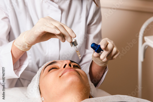 Applying a facial mask in a skin care clinic for facial skin elasticity photo