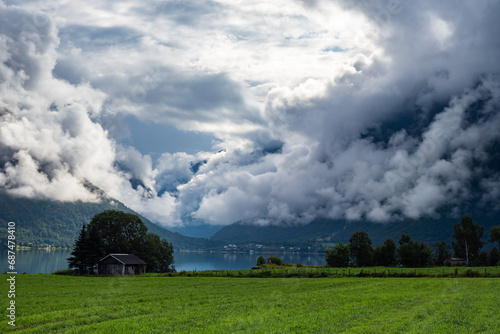 Clouds rolling in above fhord in Norway during summer