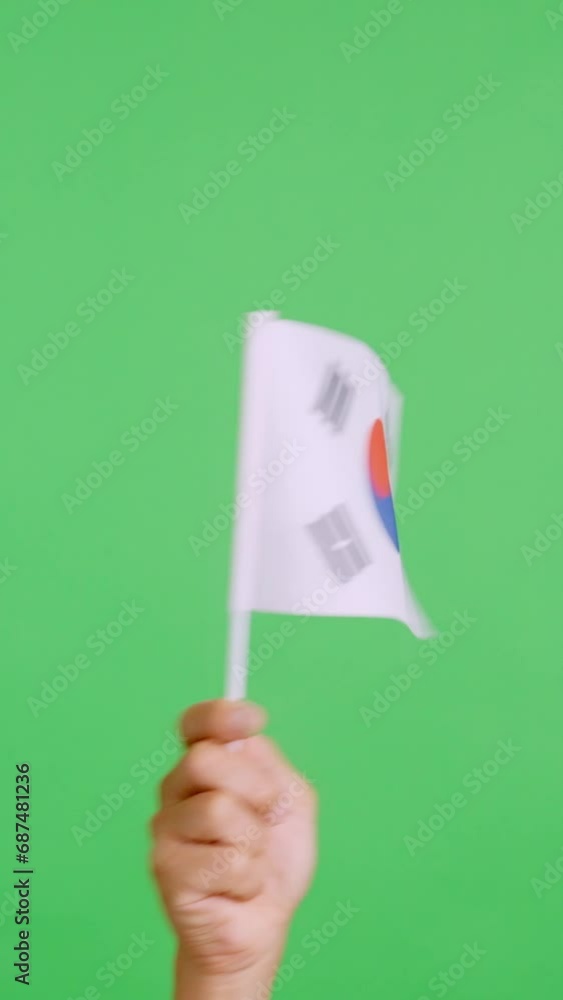 Hand waving a pennant of a south korean national flag Hand waving a pennant of a south korean national flag