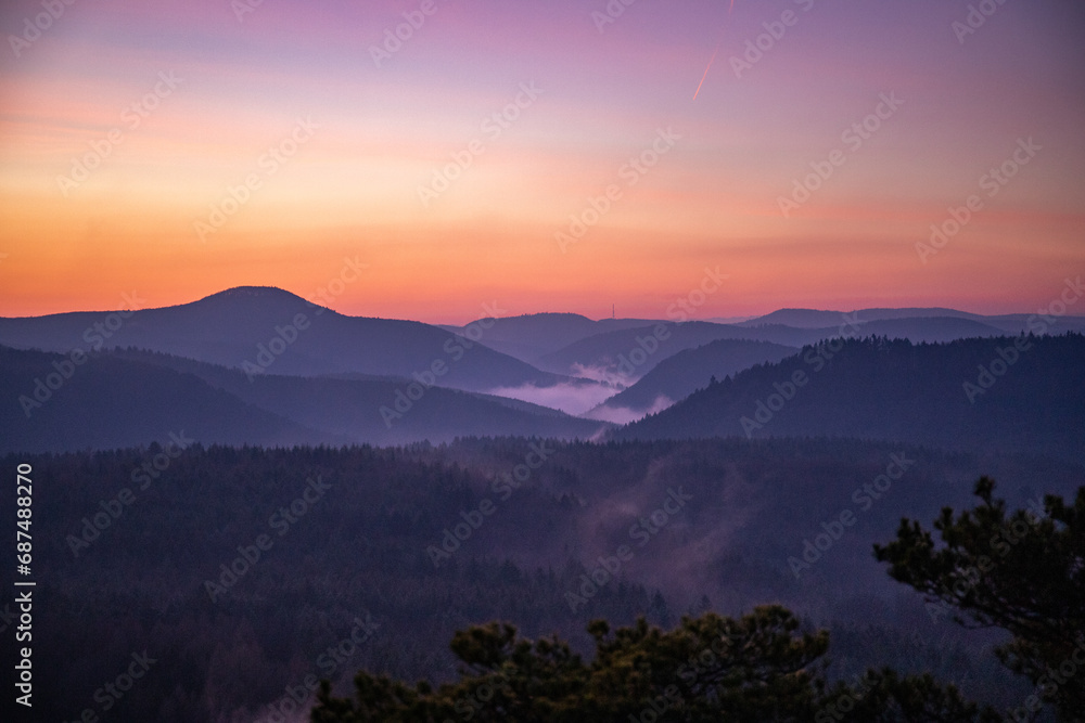 Landscape shot in sunrise, cold winter landscape from a sandstone rock in the middle of the forest. Pure nature in the morning from a viewpoint, the Schlüsselfelsen in the Palatinate Forest, Germany