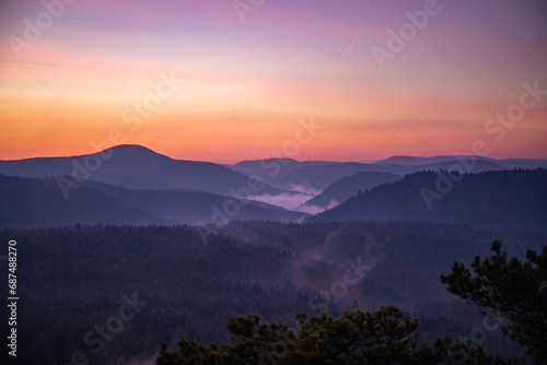 Landscape shot in sunrise, cold winter landscape from a sandstone rock in the middle of the forest. Pure nature in the morning from a viewpoint, the Schlüsselfelsen in the Palatinate Forest, Germany © Jan