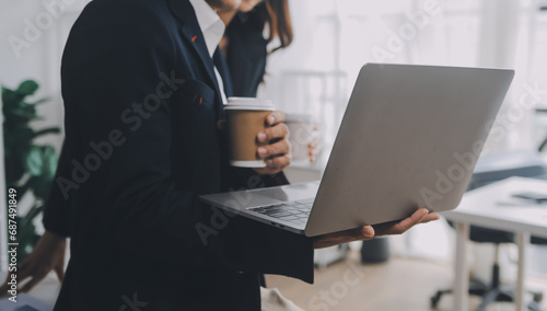 Business professionals. Group of young confident business people analyzing data using computer while spending time in the office