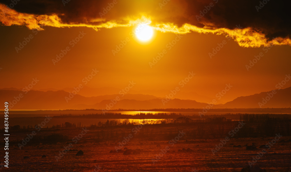 Picturesque landscape with lake at red sunset light