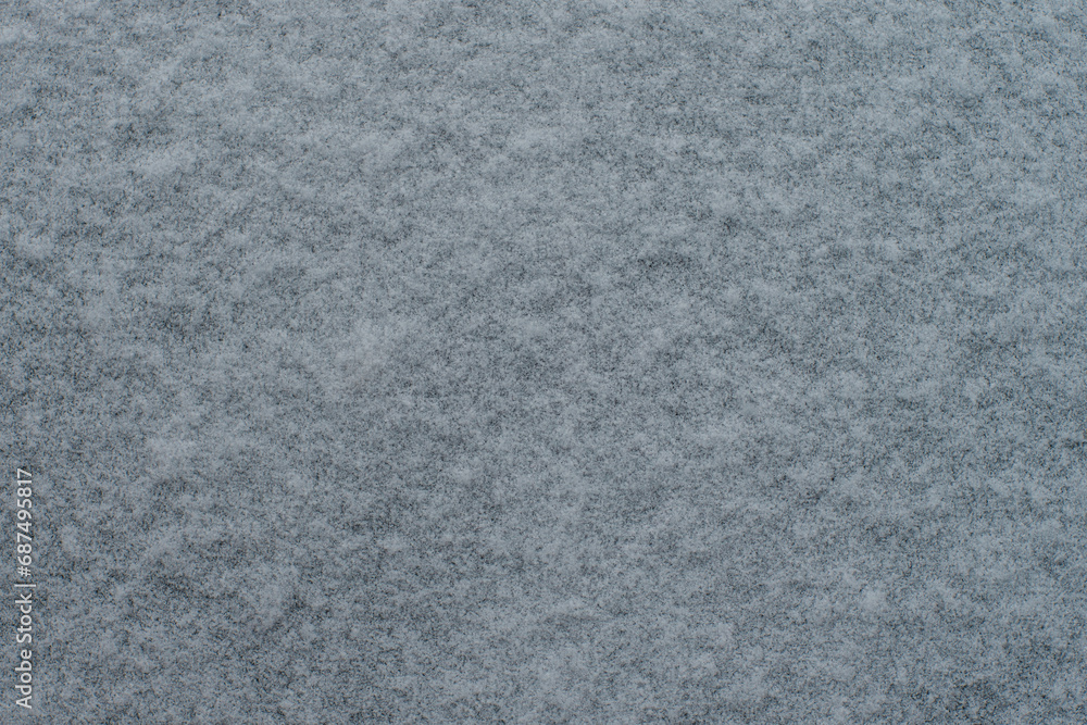 Thin layer of fresh snow on surface background or texture Thin layer of fresh snow on surface background or texture
