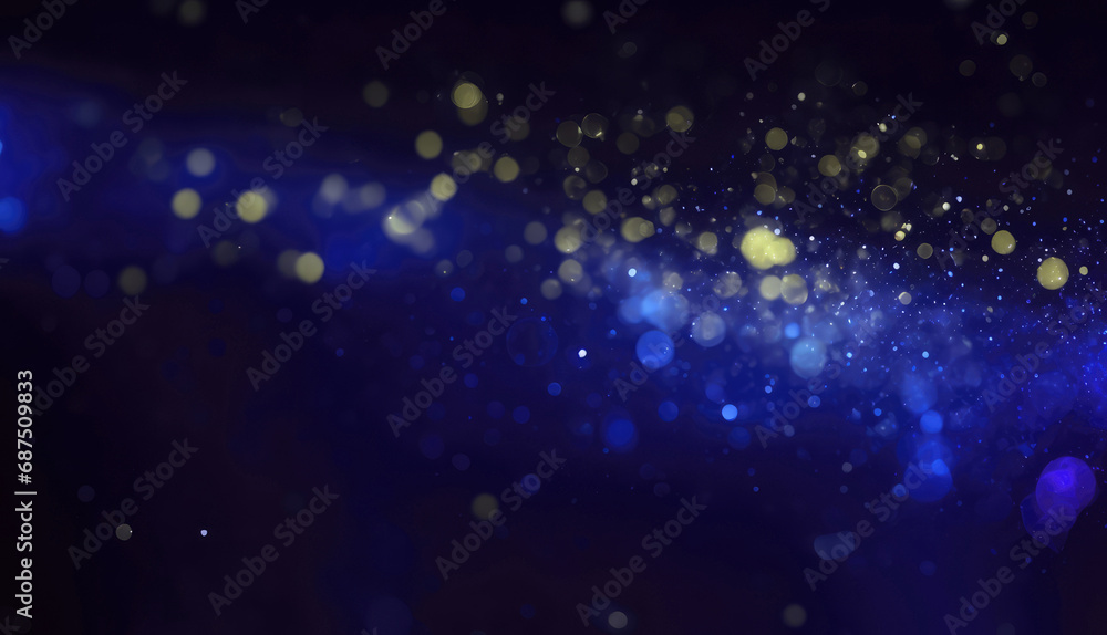 Particles of blue glow on a bokeh background. Contemporary glitter opulent golden sparkles. Blurred, defocused, abstract background for Christmas.