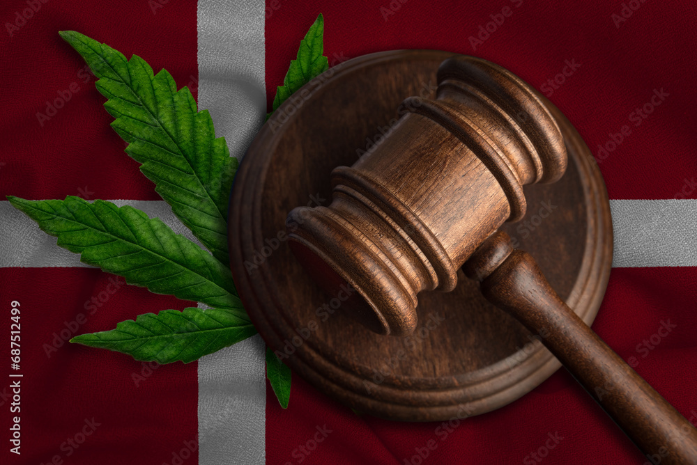 Flag of Denmark and justice gavel with cannabis leaf. Illegal growth of cannabis plant and drugs spreading